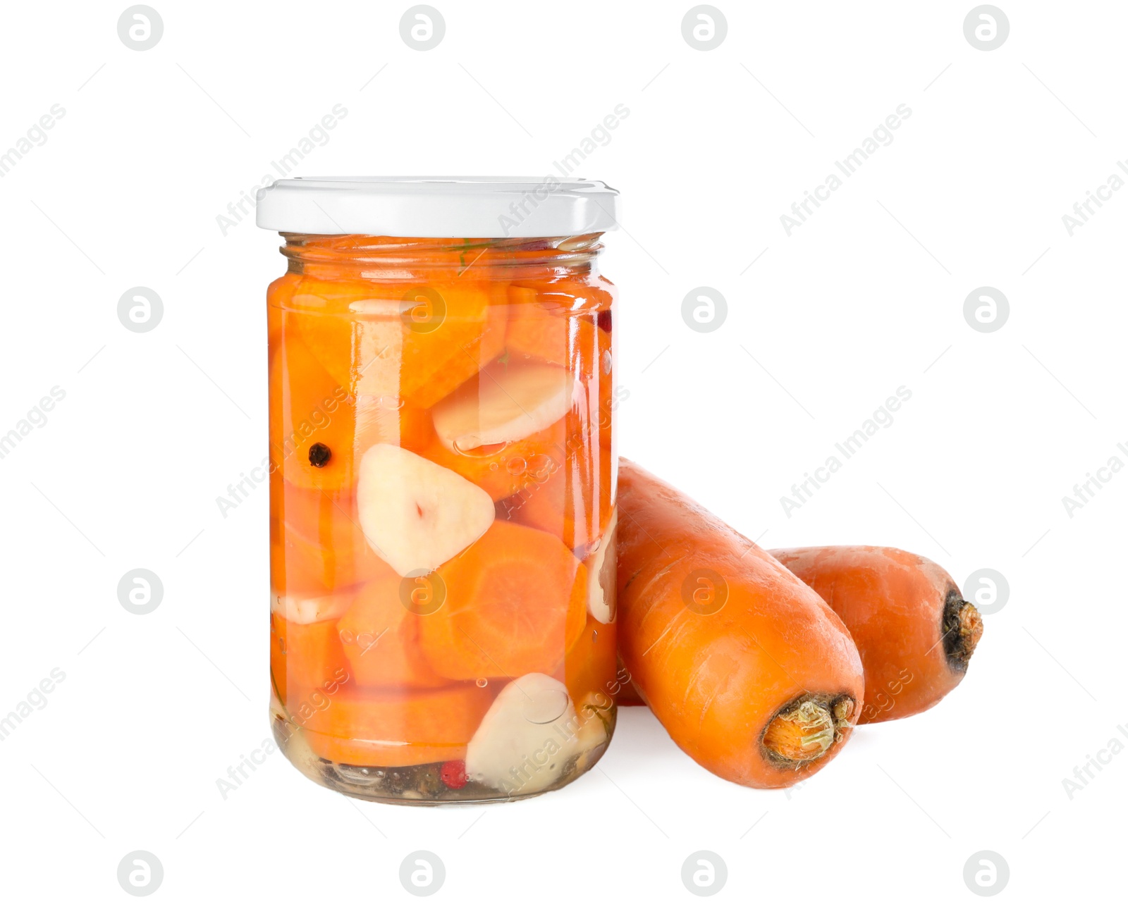 Photo of Tasty pickled carrots in jar and fresh ingredients isolated on white