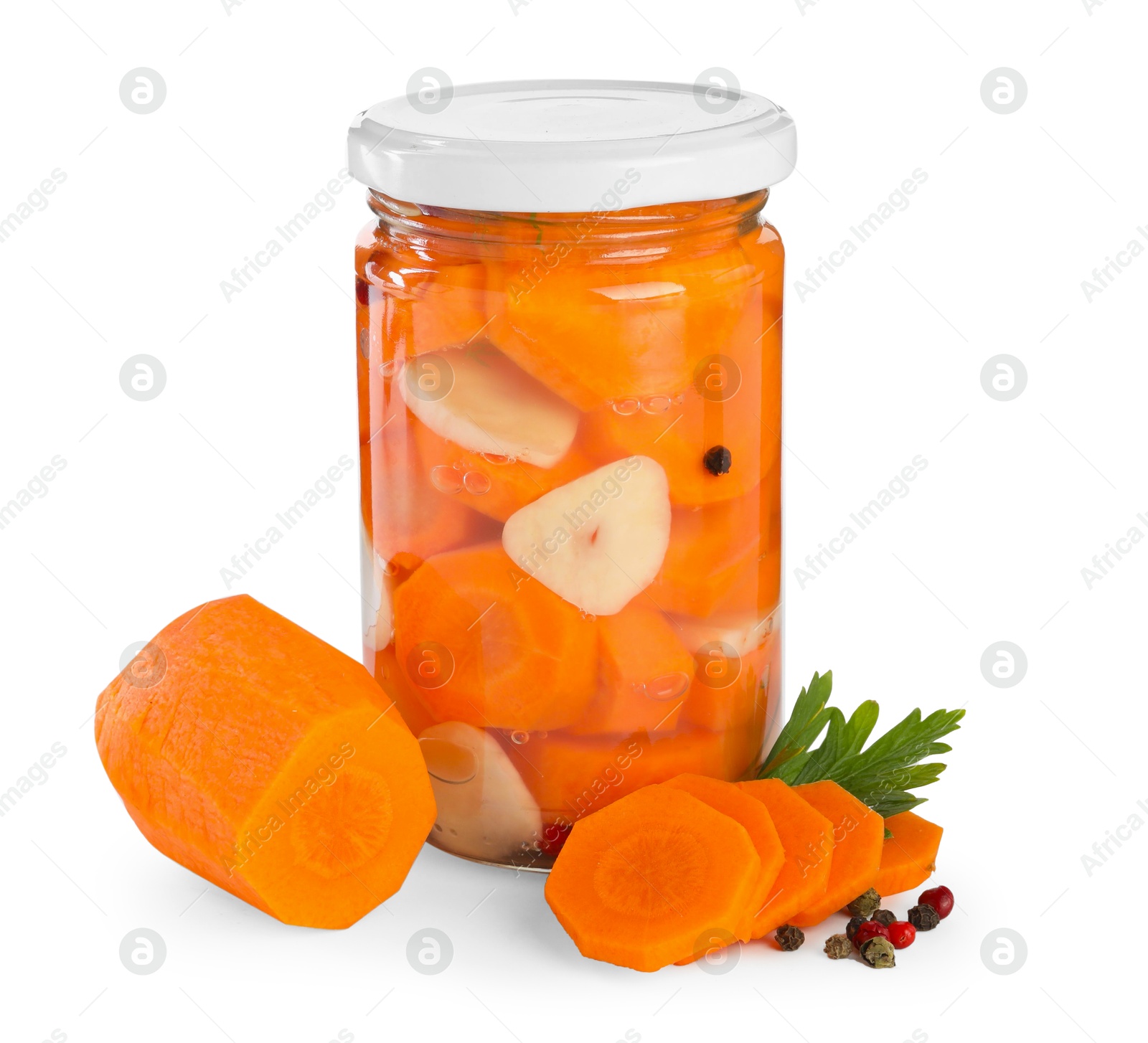 Photo of Tasty pickled carrots in jar and fresh ingredients isolated on white