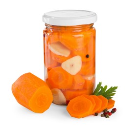 Photo of Tasty pickled carrots in jar and fresh ingredients isolated on white