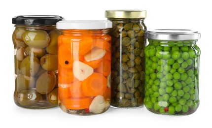 Photo of Different pickled products in jars isolated on white