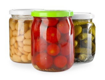 Photo of Different pickled products in jars isolated on white