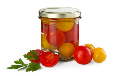 Photo of Tasty pickled tomatoes in jar, fresh vegetables and parsley isolated on white