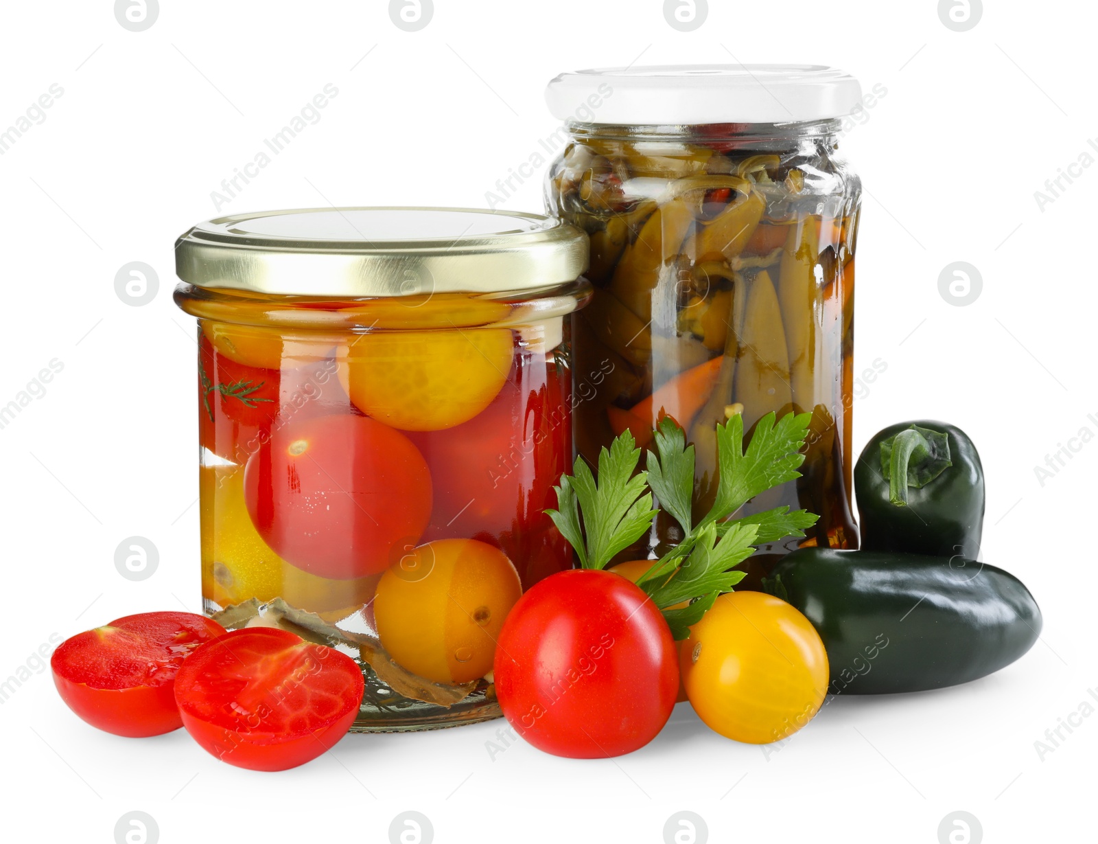 Photo of Tasty pickled vegetables in jars and fresh ingredients isolated on white