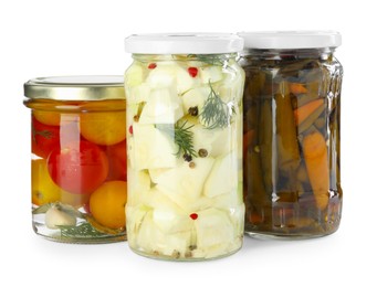 Photo of Different pickled products in jars isolated on white