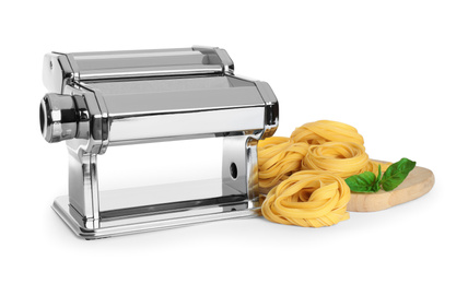 Modern pasta maker machine and tagliatelle isolated on white