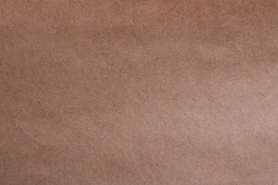 Photo of Texture of kraft paper bag as background, closeup