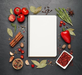Photo of Blank recipe book and different ingredients on black table, flat lay. Space for text