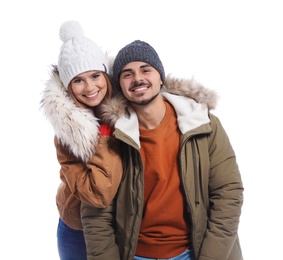 Young couple wearing warm clothes on white background. Ready for winter vacation