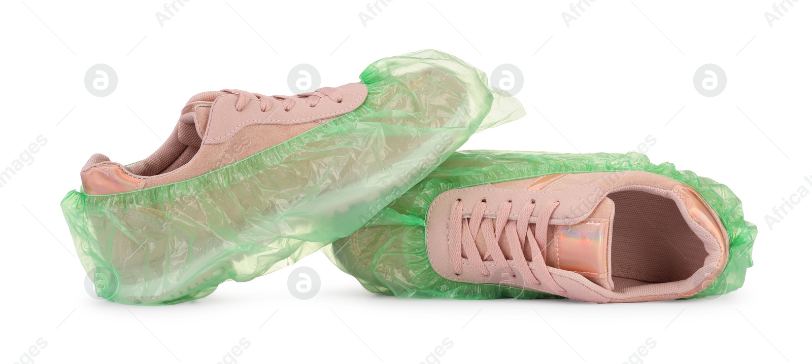 Photo of Sneakers in green shoe covers isolated on white