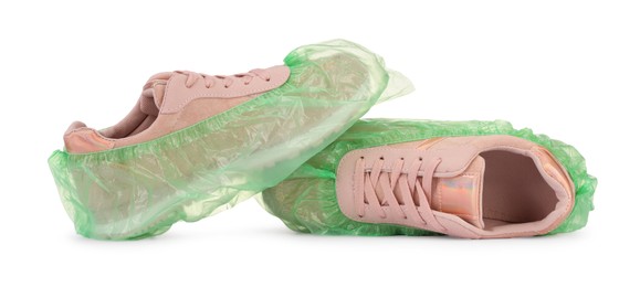 Sneakers in green shoe covers isolated on white