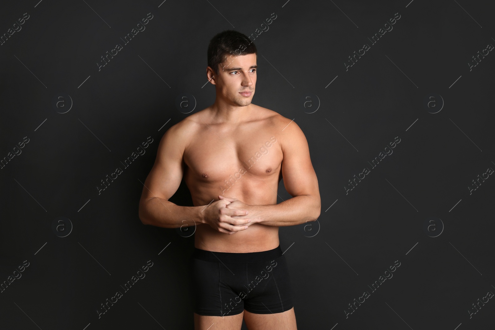 Photo of Man with sexy body on black background