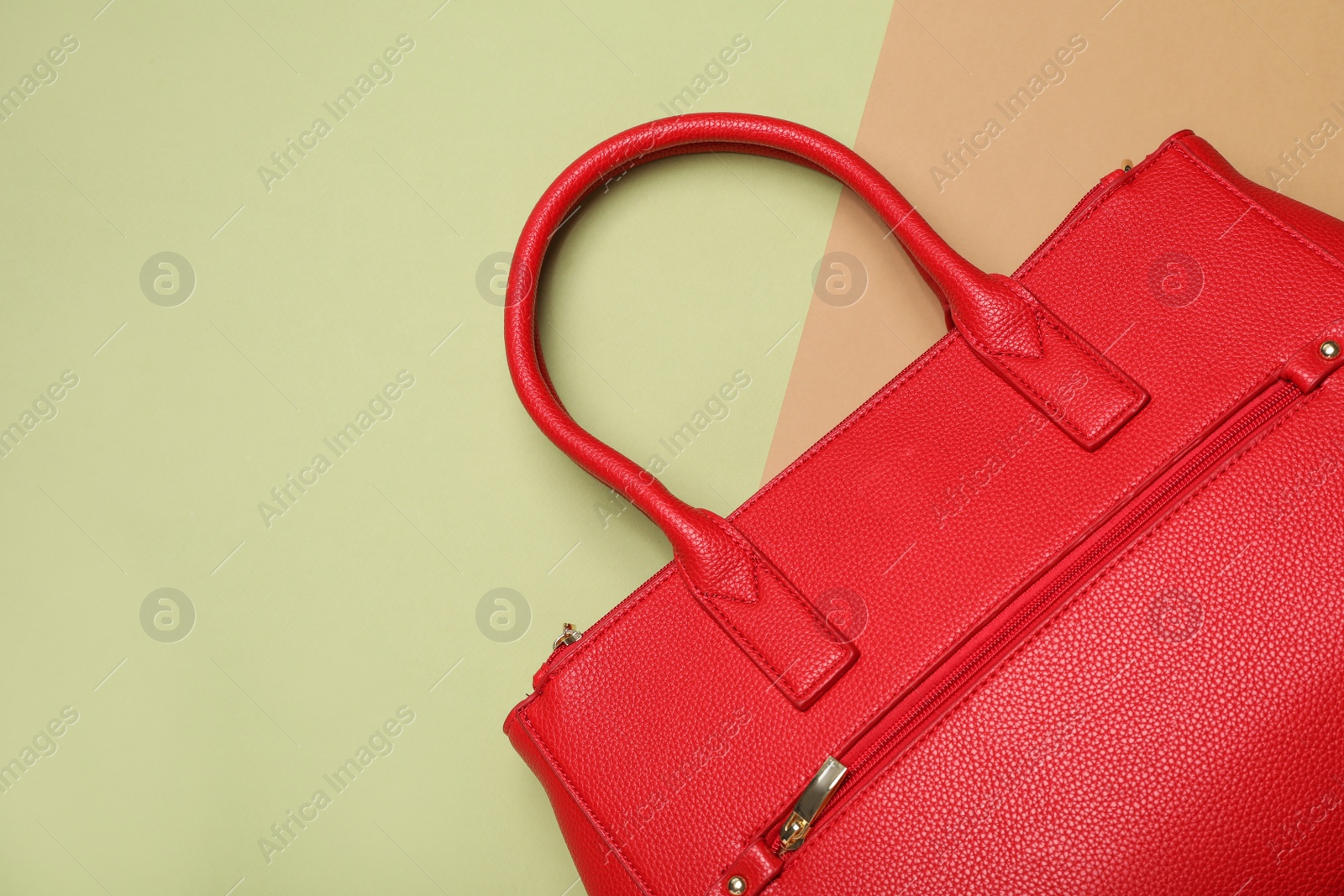 Photo of Stylish women's bag on color background, top view. Space for text