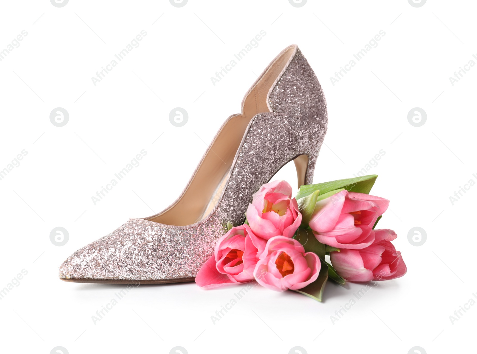 Photo of Stylish lady's shoe and beautiful spring tulips on white background. International Women's Day