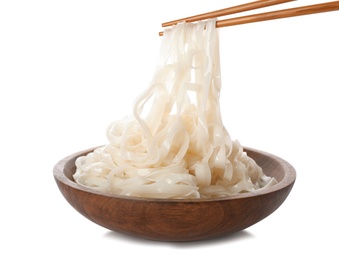 Taking rice noodles with chopsticks from bowl on white background