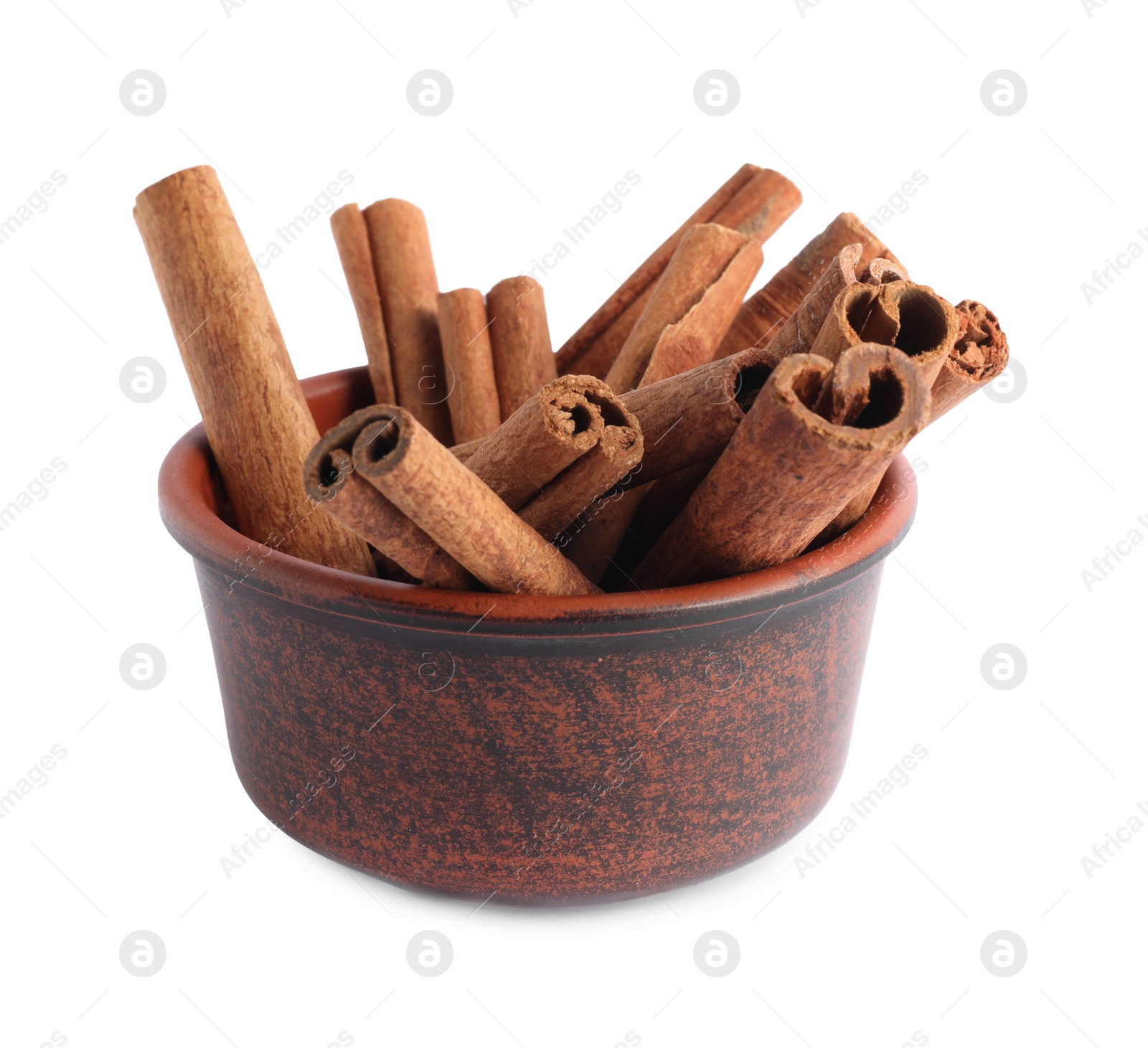 Photo of Dry aromatic cinnamon sticks in bowl isolated on white