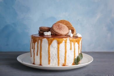 Photo of Delicious homemade cake with caramel sauce on table