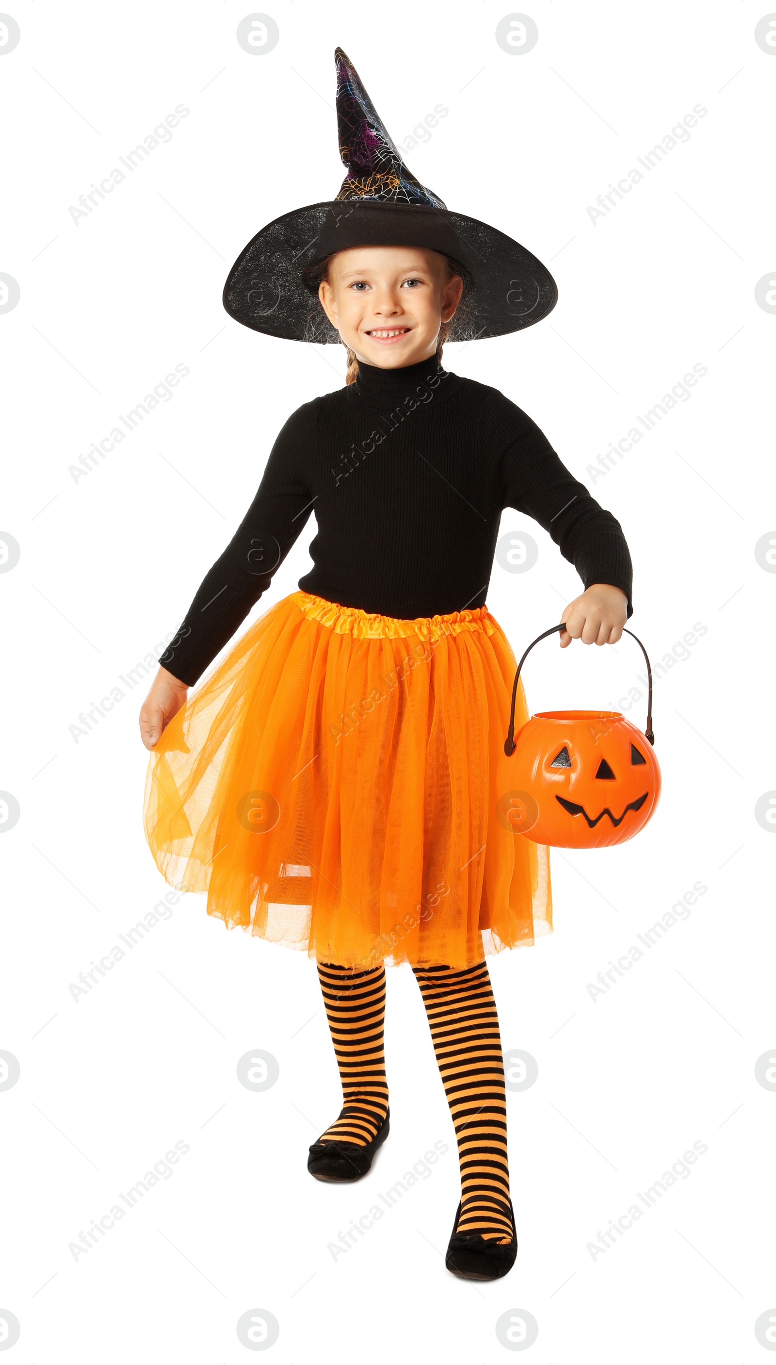 Photo of Cute little girl with pumpkin candy bucket wearing Halloween costume on white background