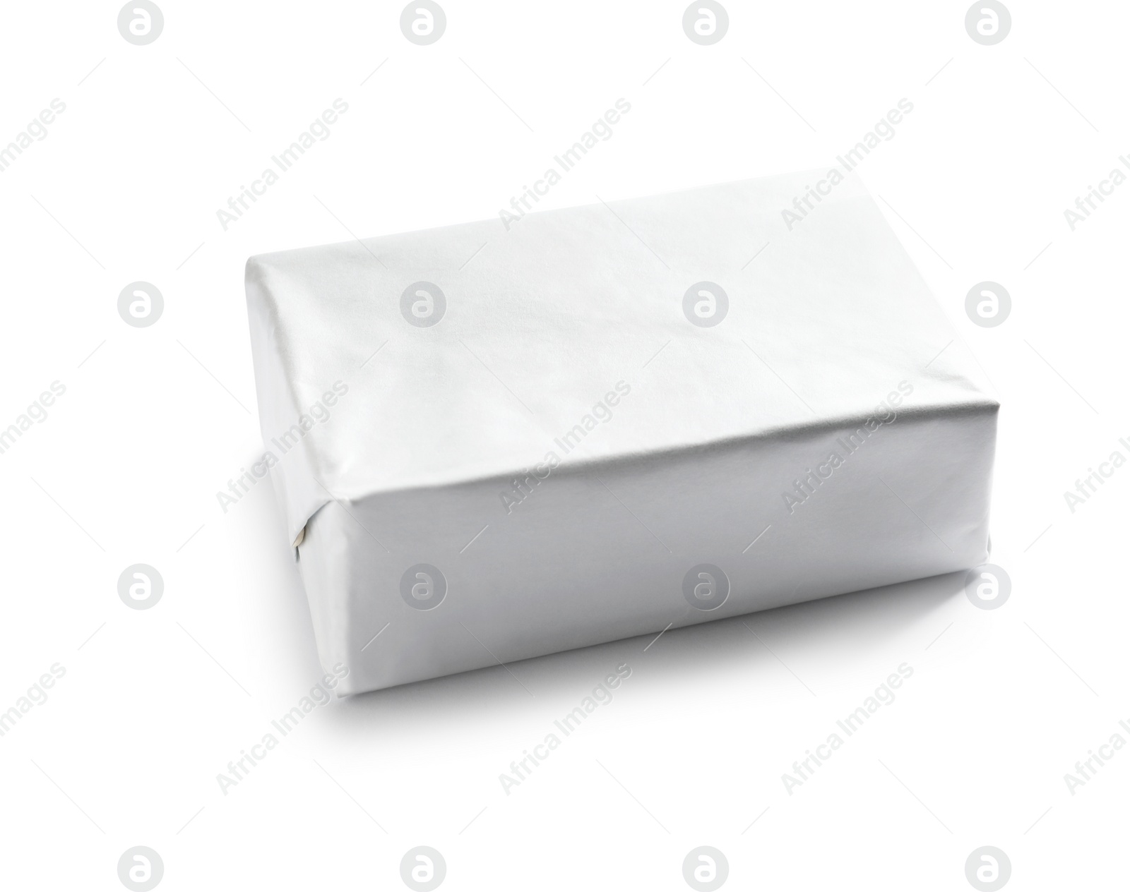 Photo of Block of butter in paper wrapper on white background