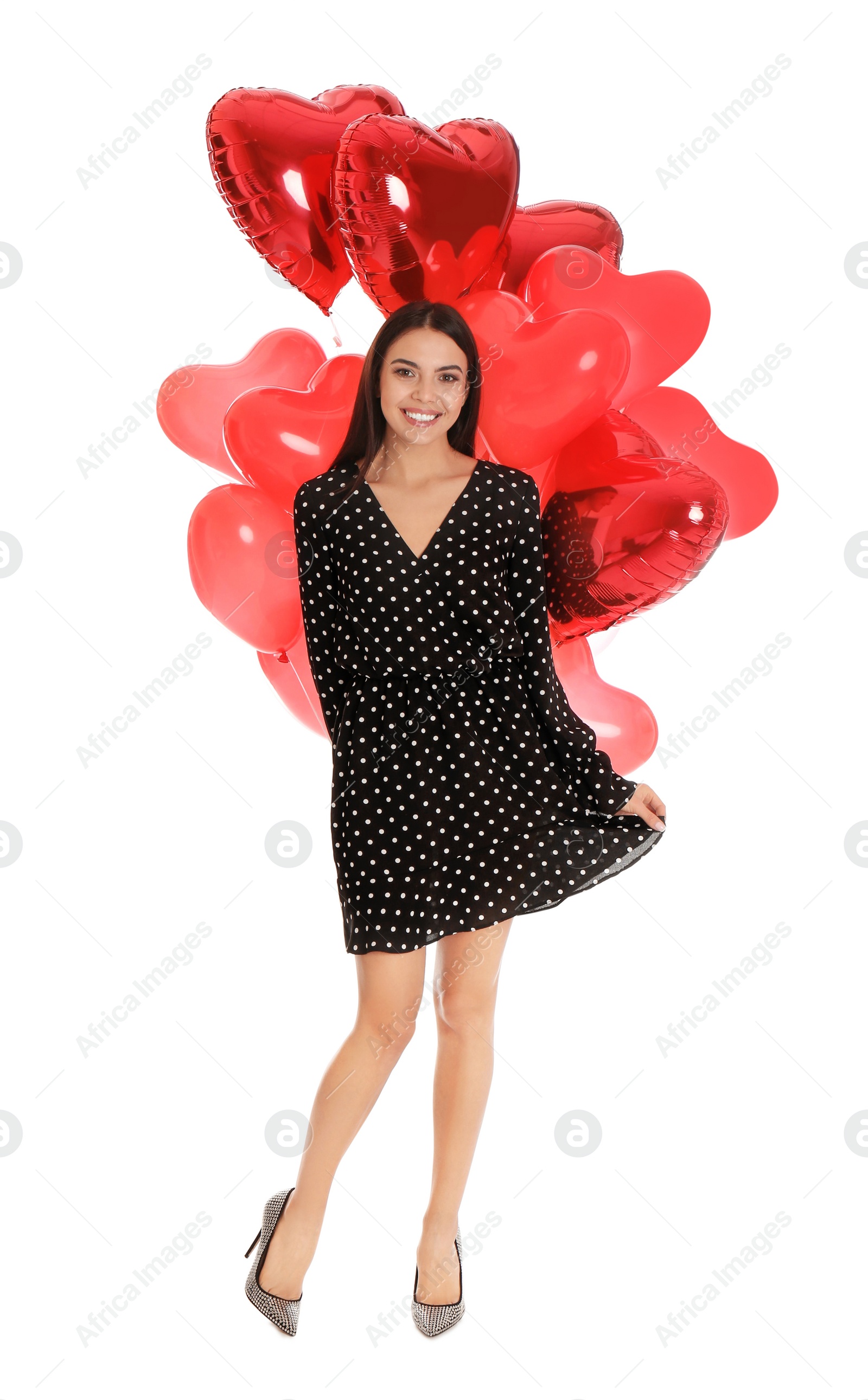 Photo of Beautiful young woman with heart shaped balloons isolated on white. Valentine's day celebration