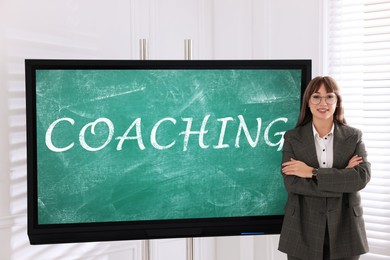 Business trainer near interactive board in meeting room