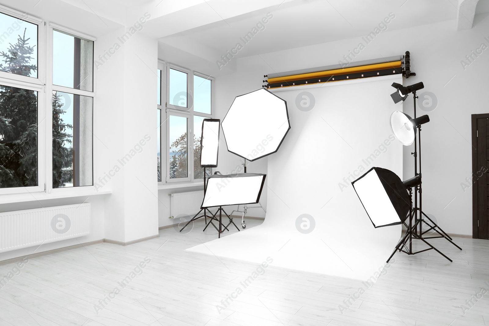 Photo of Interior of modern photo studio with professional lighting equipment