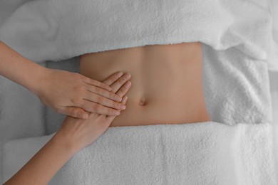 Photo of Woman receiving professional belly massage, closeup view