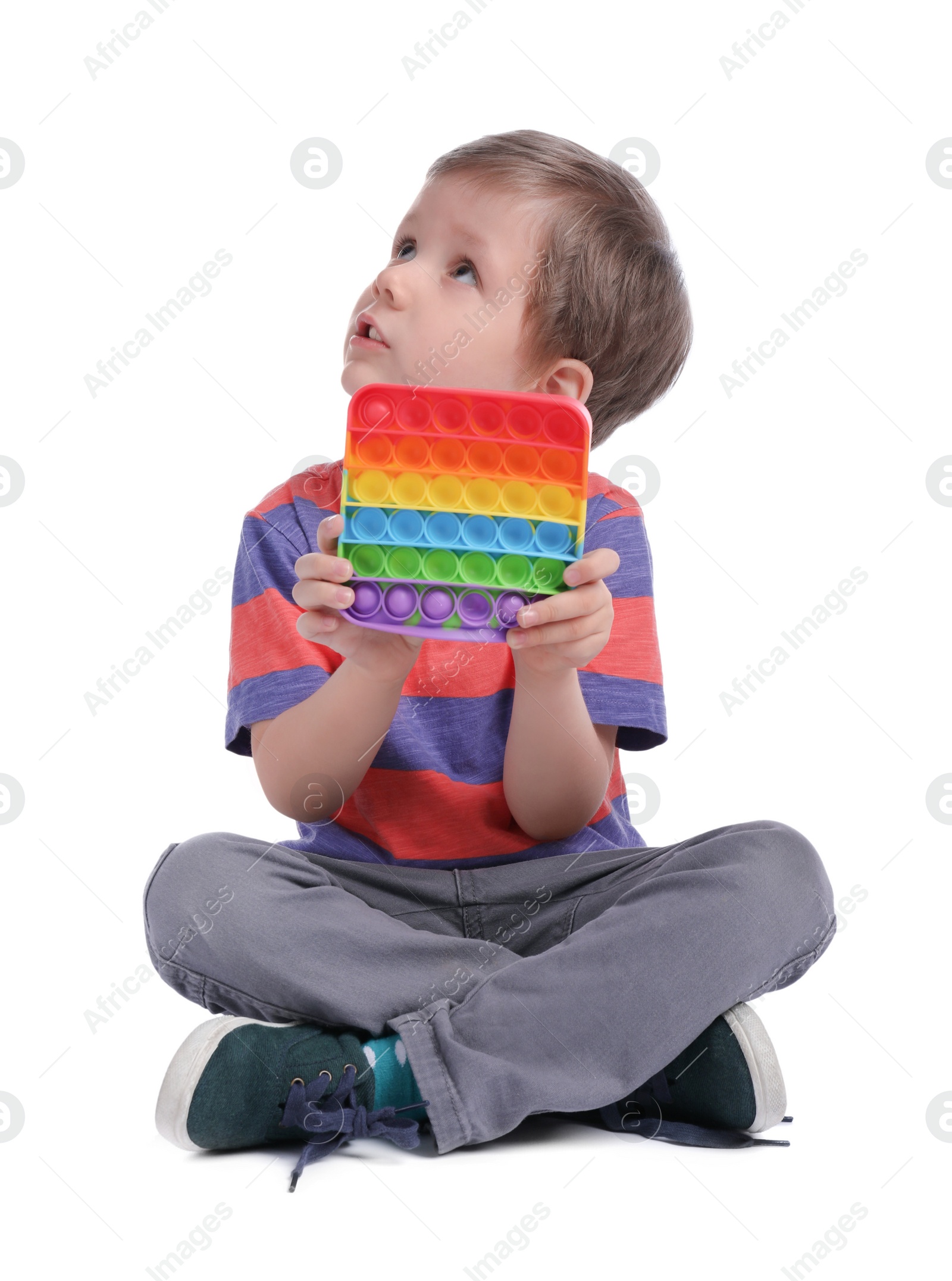 Photo of Little boy with pop it fidget toy on white background