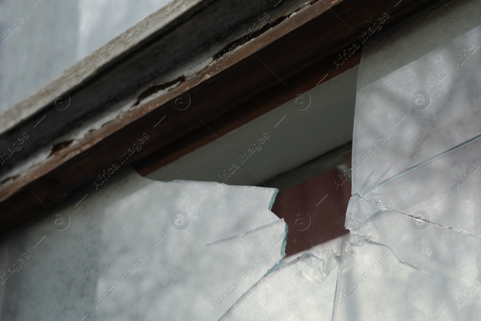 Photo of Broken window of abandoned house outdoors, closeup. Requiring repair