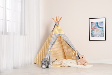 Photo of Cozy child room interior with play tent near window