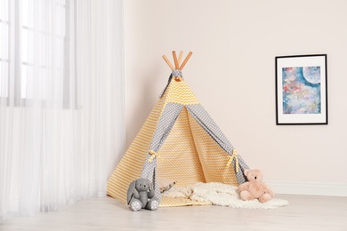 Cozy child room interior with play tent near window