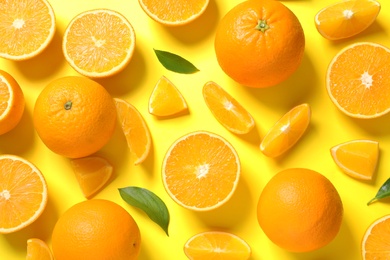 Flat lay composition with ripe oranges on color background