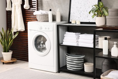 Stylish laundry room with modern washing machine. Interior design