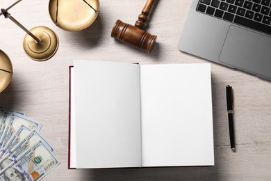 Photo of Tax law. Flat lay composition with open book and gavel on wooden table