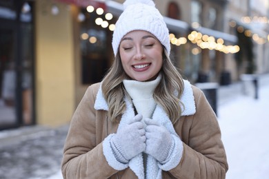 Portrait of smiling woman on city street in winter