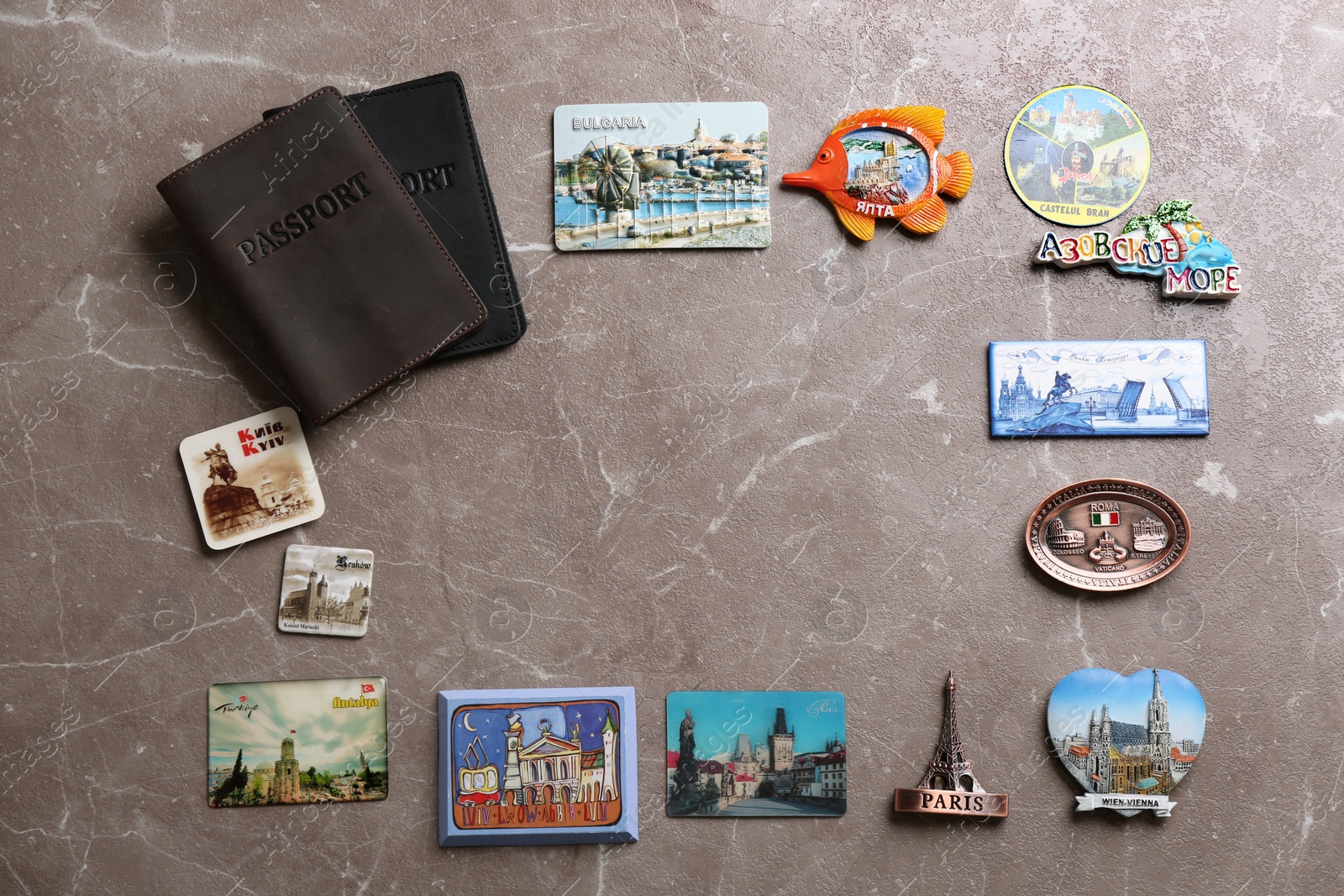 Photo of MYKOLAIV, UKRAINE - DECEMBER 25, 2018: Flat lay composition with passports, magnets and space for text on color background