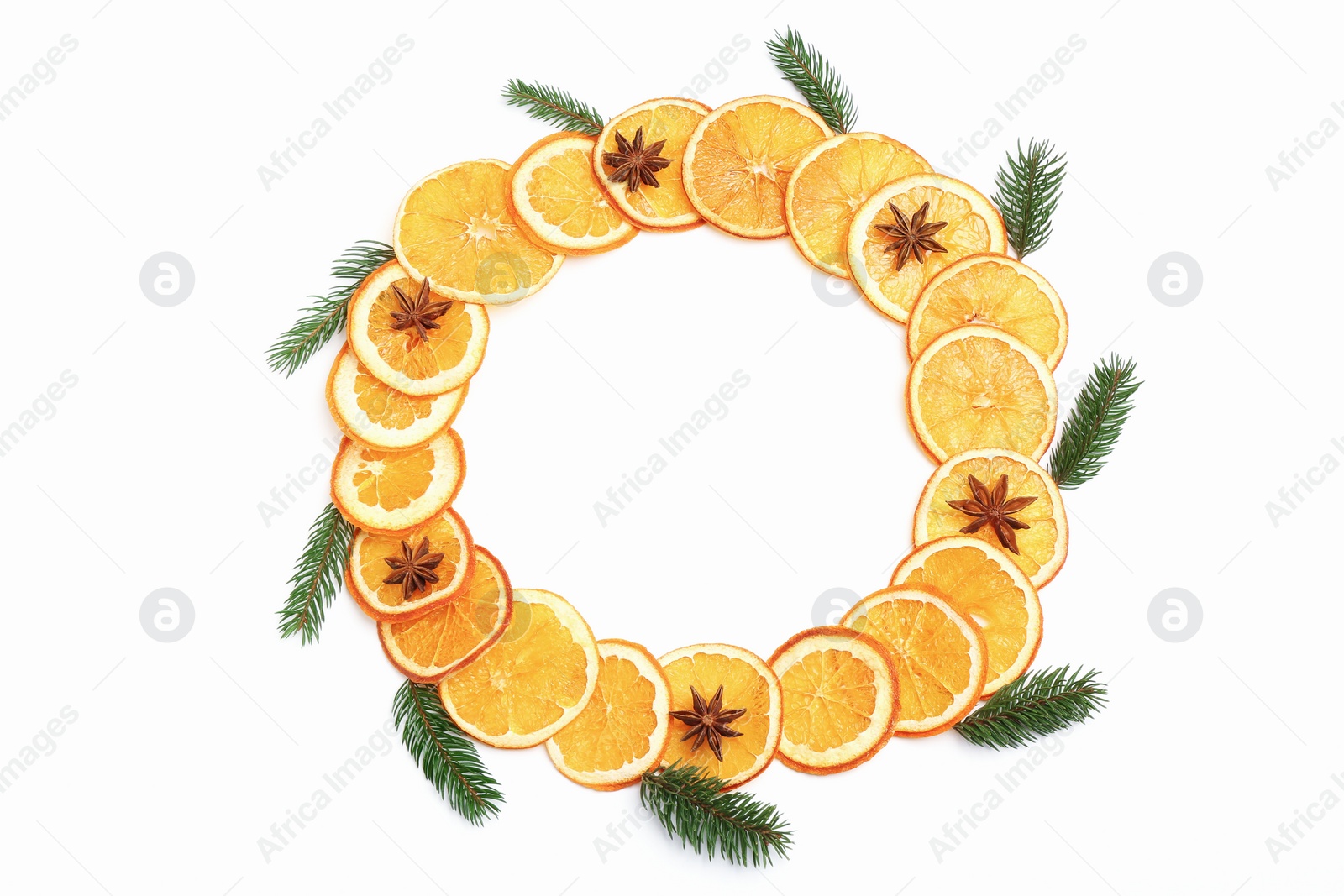 Photo of Frame made of dry orange slices, fir branches and anise stars on white background, flat lay