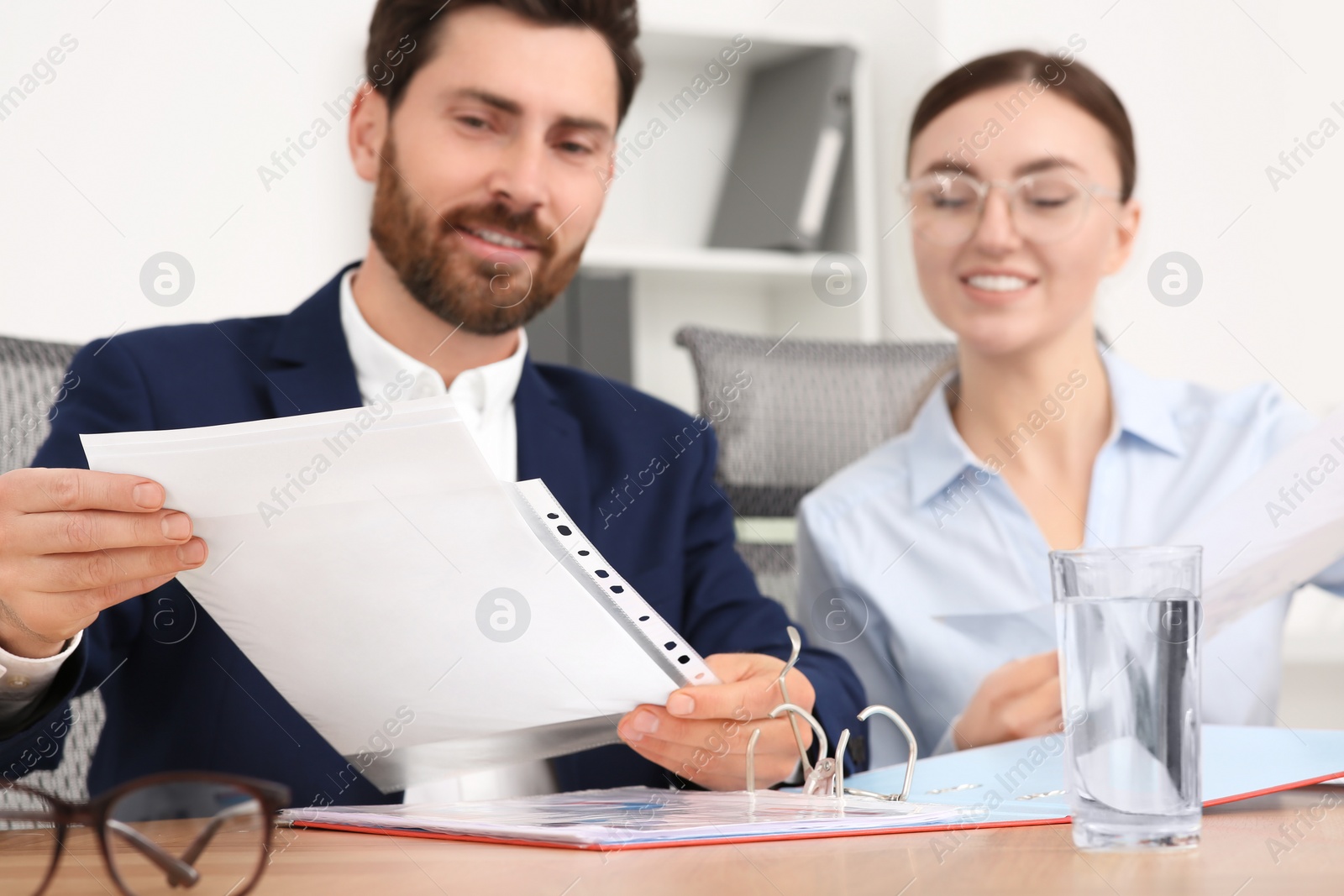 Photo of Businesspeople working together with documents in office