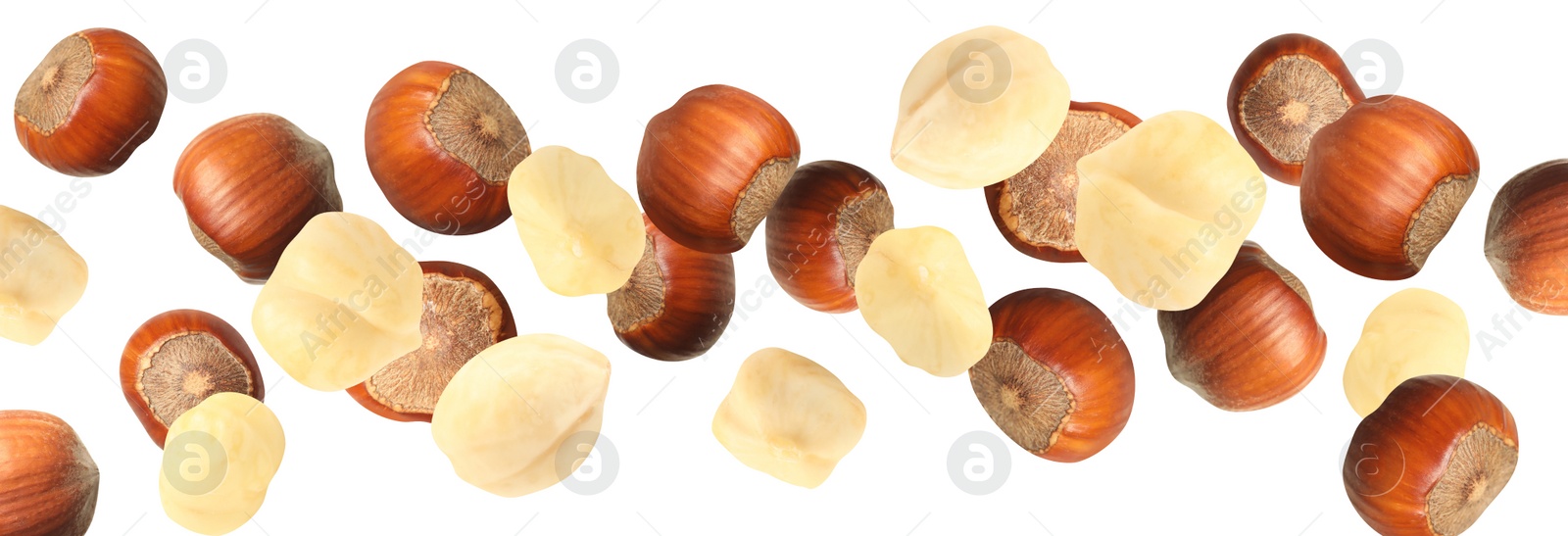 Image of Tasty hazelnuts falling on white background, banner design. Healthy snack