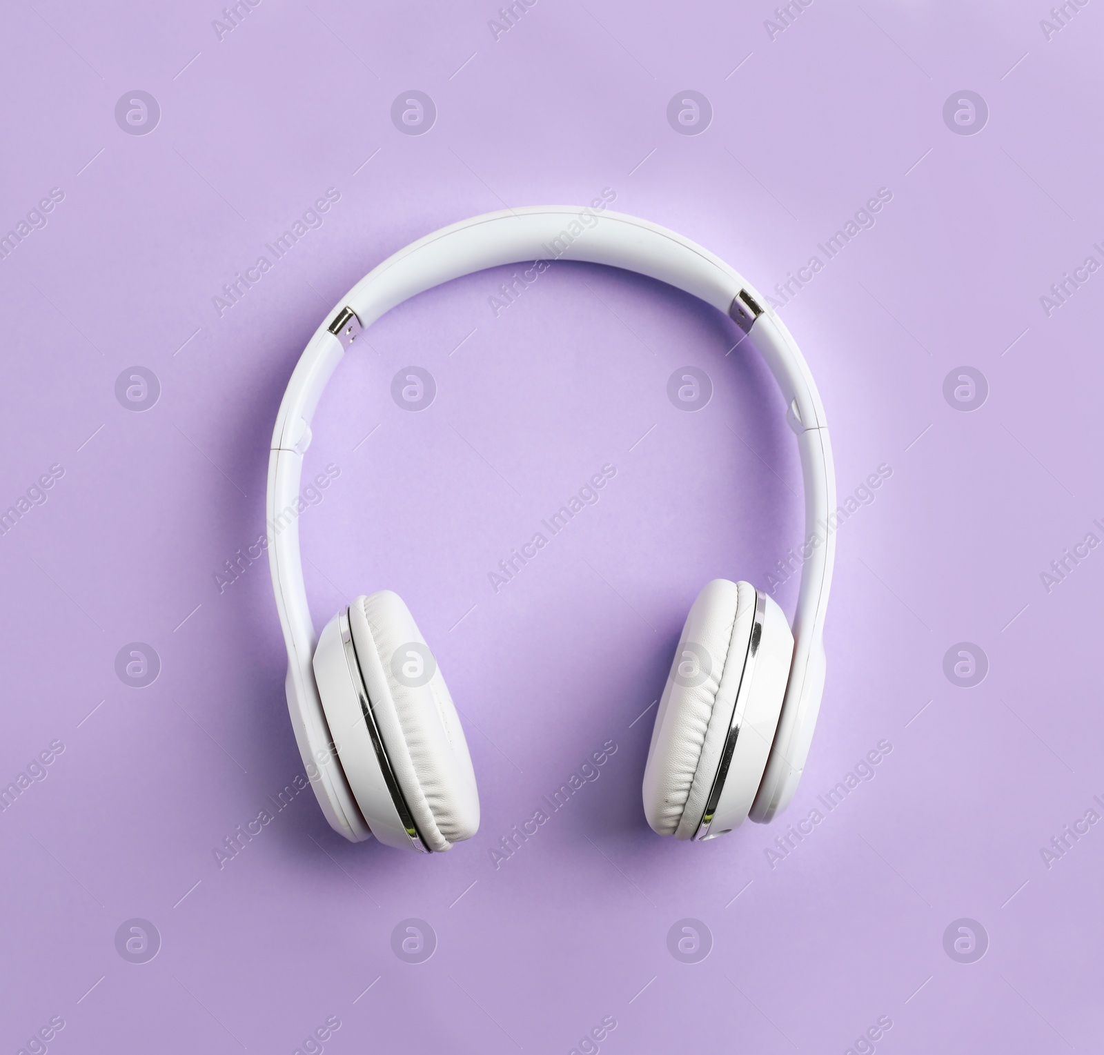 Photo of Wireless headphones on color background, top view