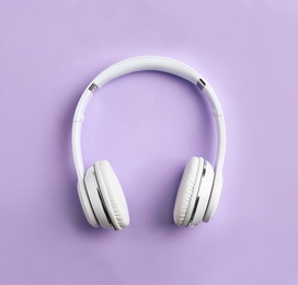 Wireless headphones on color background, top view