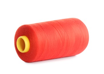 Photo of Spool of red sewing thread isolated on white