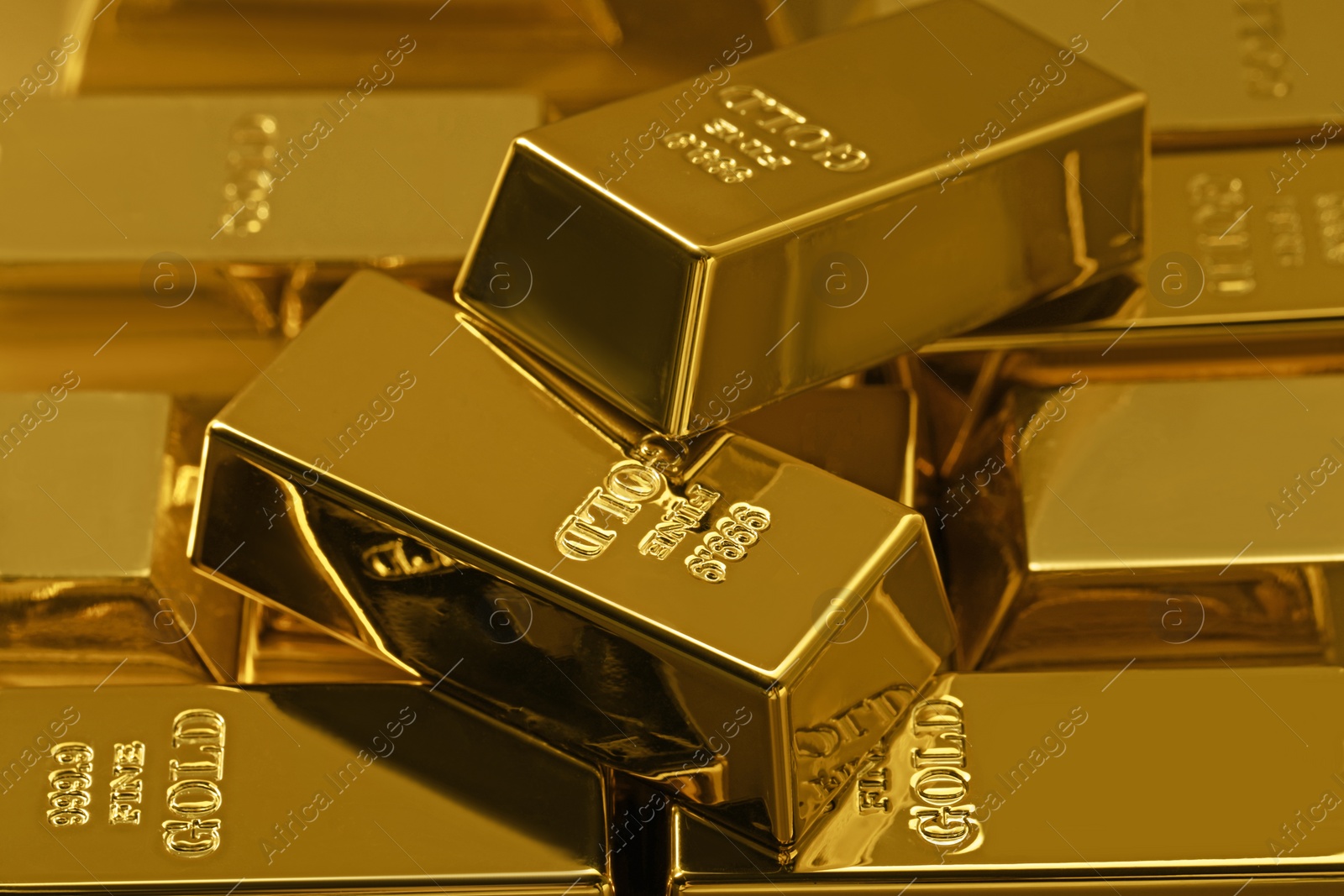Photo of Many shiny gold bars as background, closeup