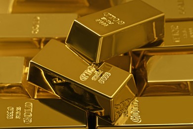 Many shiny gold bars as background, closeup