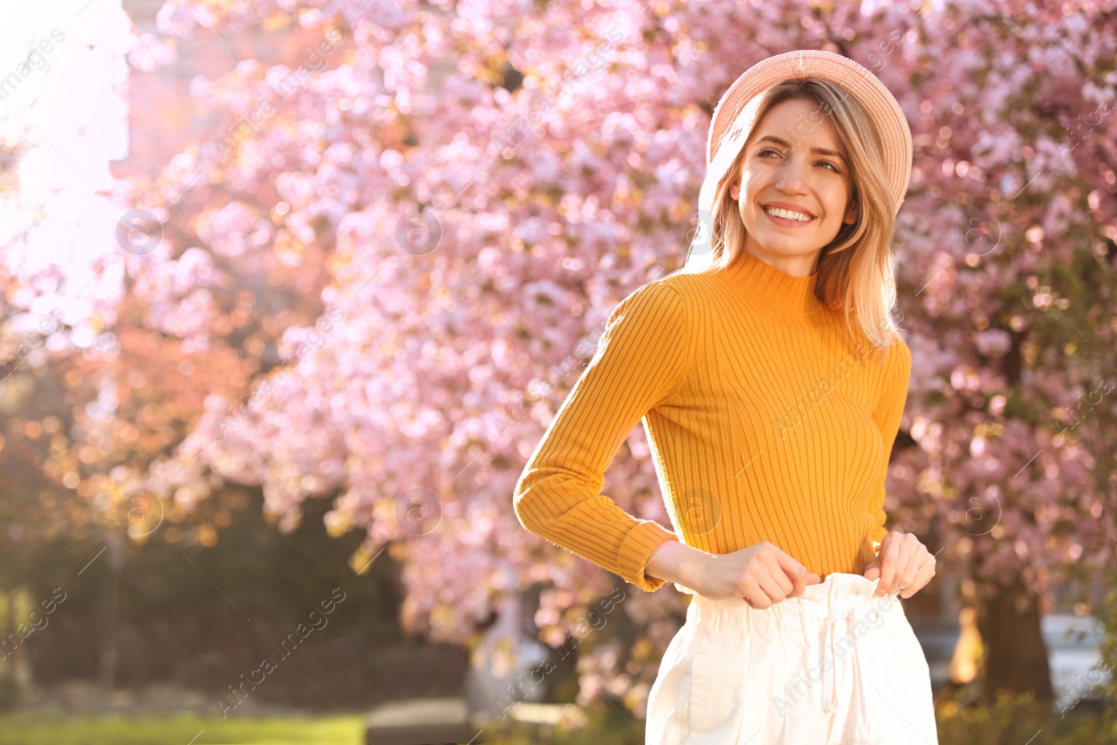 Photo of Young woman wearing stylish outfit in park on spring day. Fashionable look