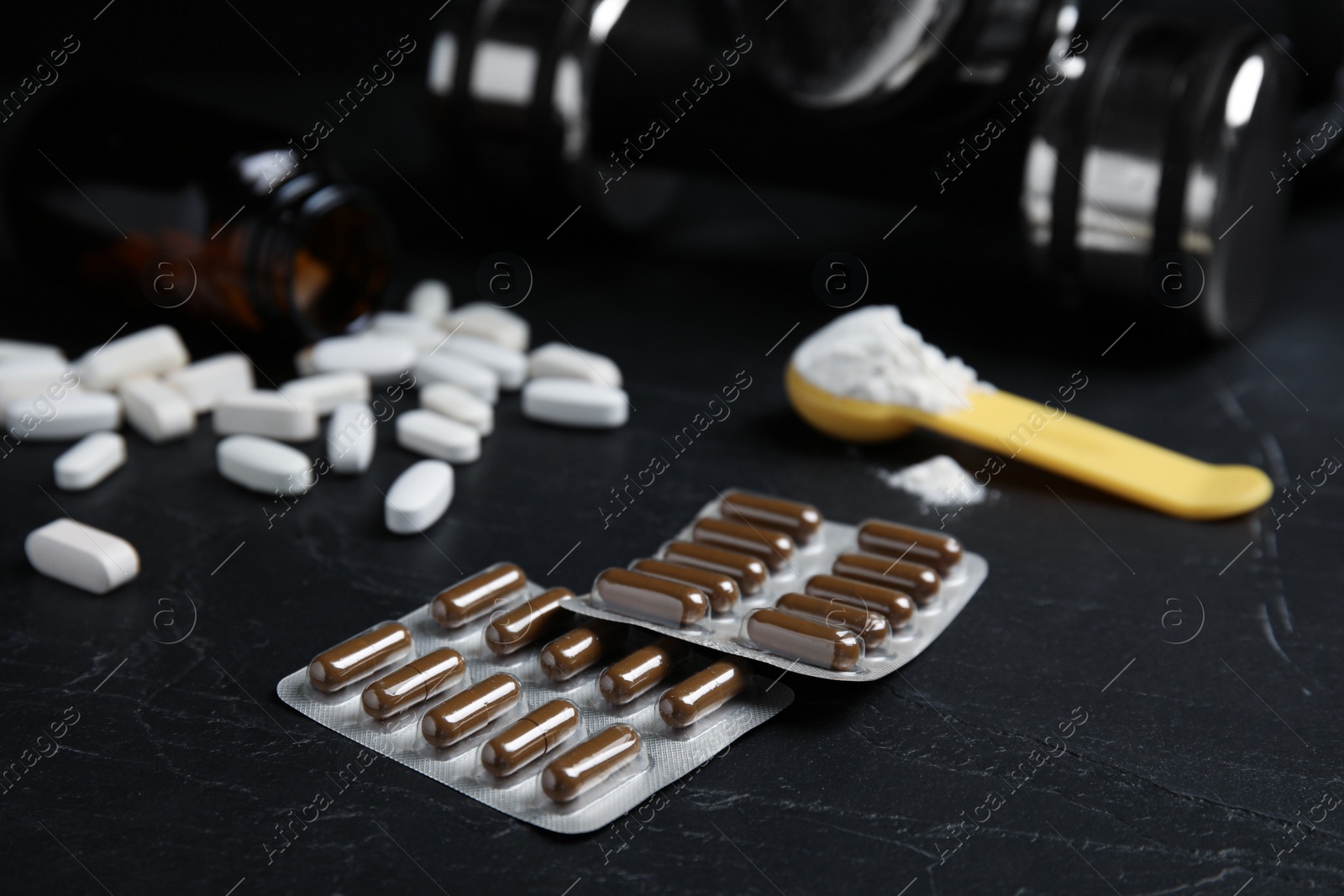 Photo of Blister packs with amino acid pills on black table