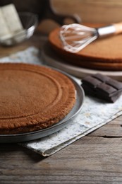 Ingredients for delicious homemade layer cake preparing on wooden table