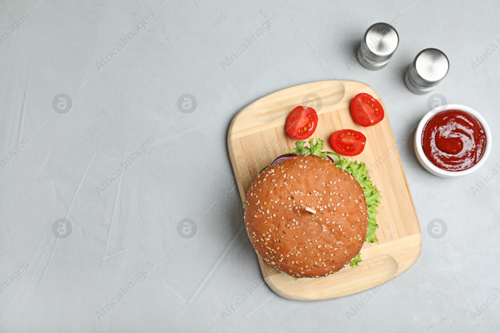 Photo of Flat lay composition with tasty burger on table. Space for text