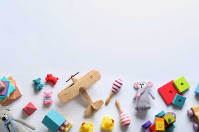 Photo of Flat lay composition with different toys on white background. Space for text