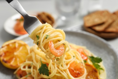 Photo of Eating of delicious pasta with shrimp, closeup