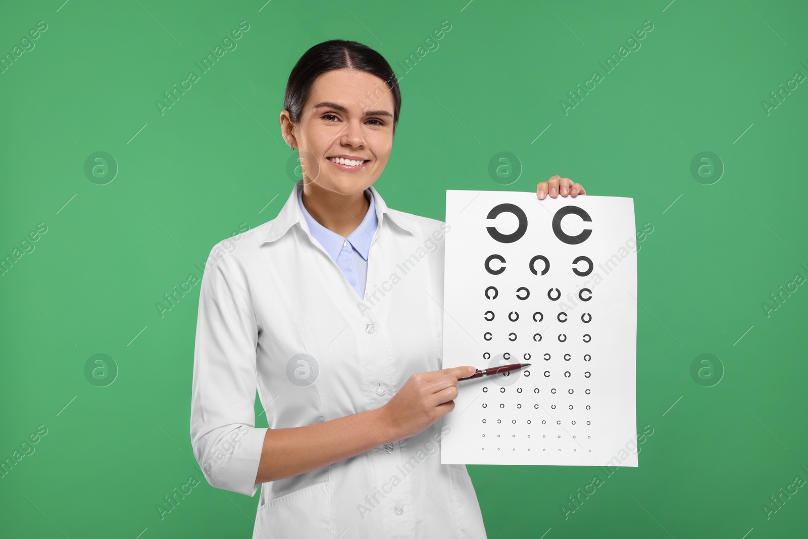 Photo of Ophthalmologist pointing at vision test chart on green background